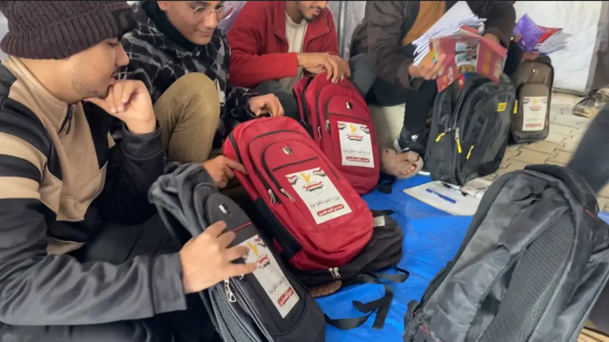 Egyptian committee distributes school bags and stationery to students in the sector